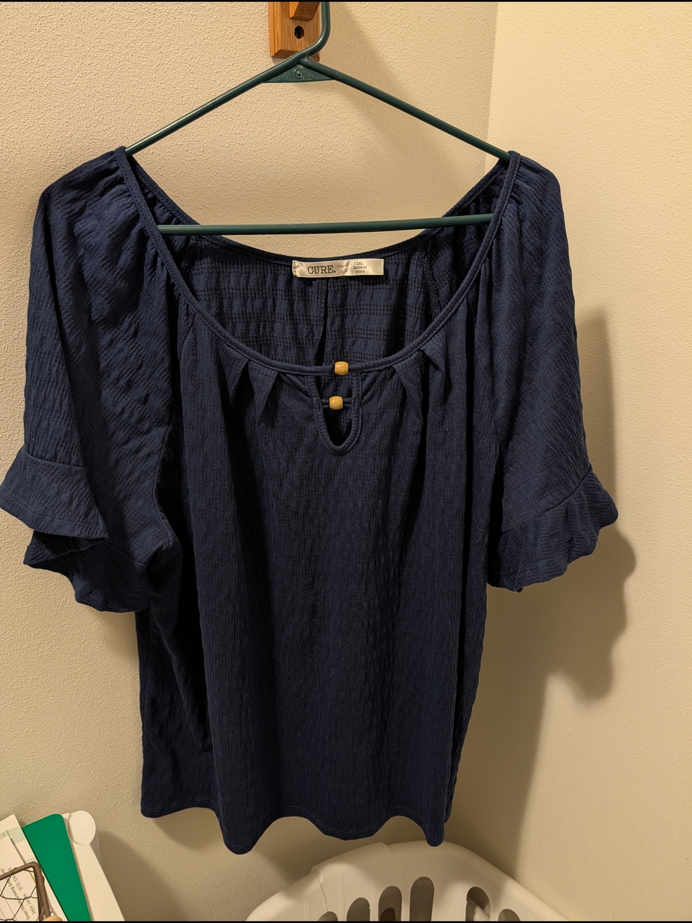 Cure Navy Ruffle-Sleeve Keyhole Blouse with Wooden Bead Detail